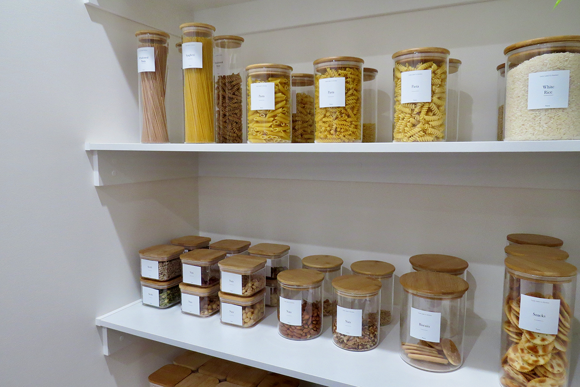 Organised pantry shelves with labelled containers